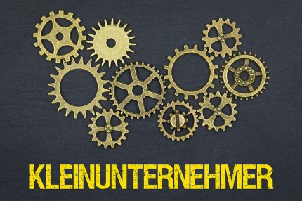 Zahnräder und Schriftzug Kleinunternehmer